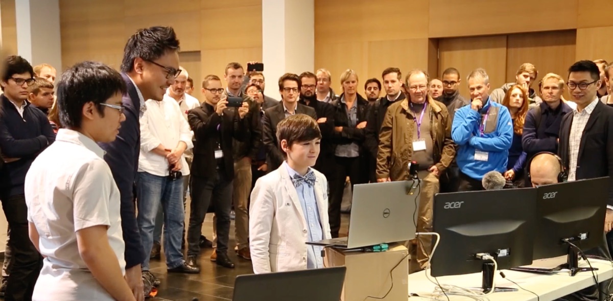 A young Marcel presenting to a crowd at an MIT research event